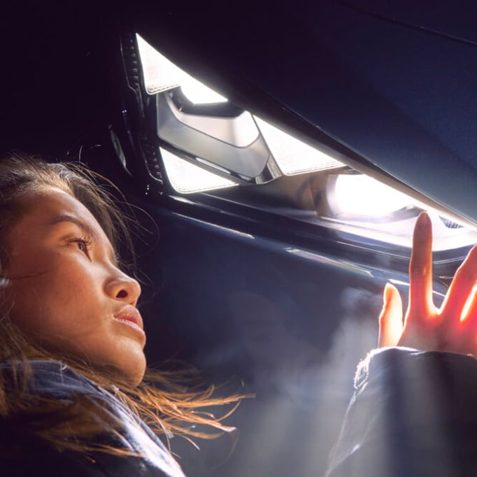 A woman looking at a headlight