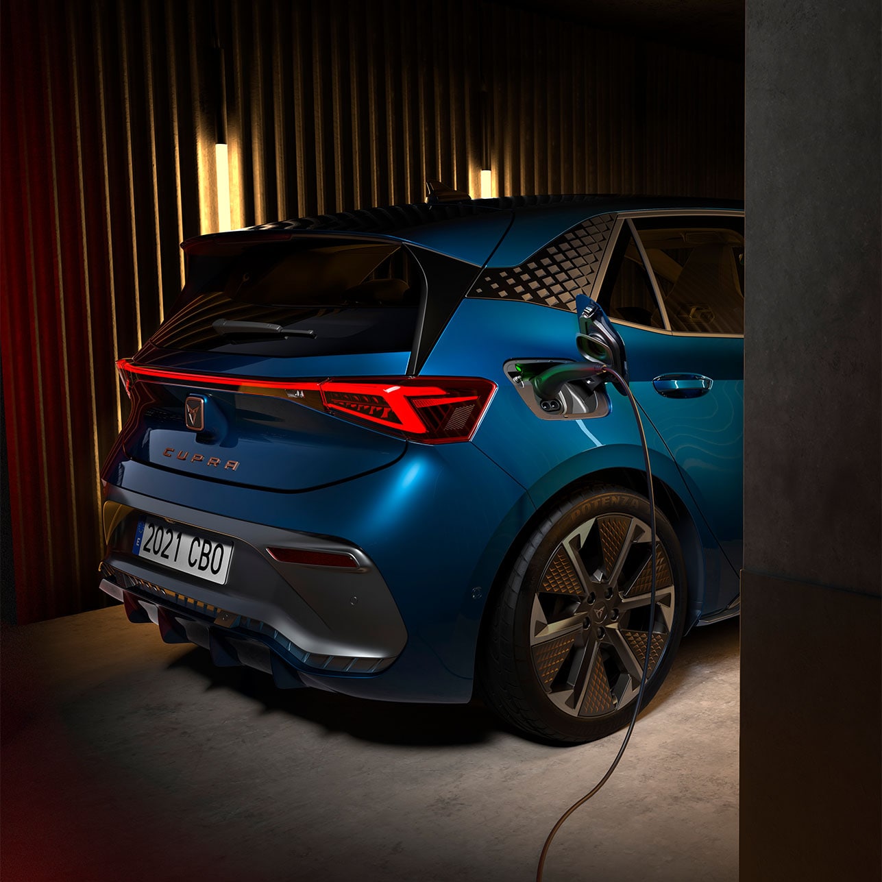 a dark blue CUPRA Born parked and charging