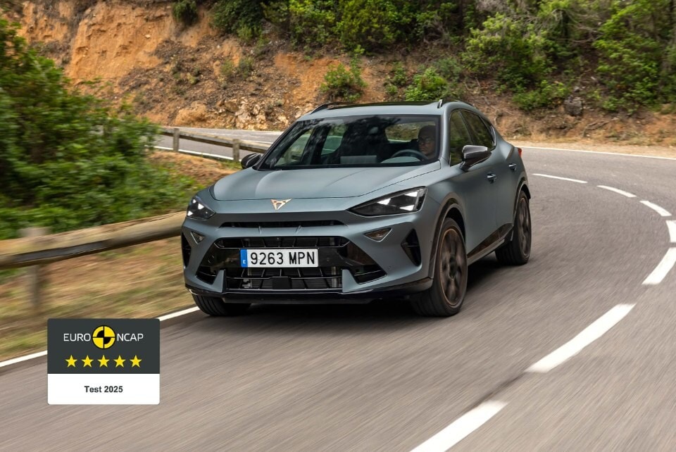 3/4 front view of the CUPRA Formentor in Matt Grey driving on a road. The car received a 5-star Euro NCAP safety rating.