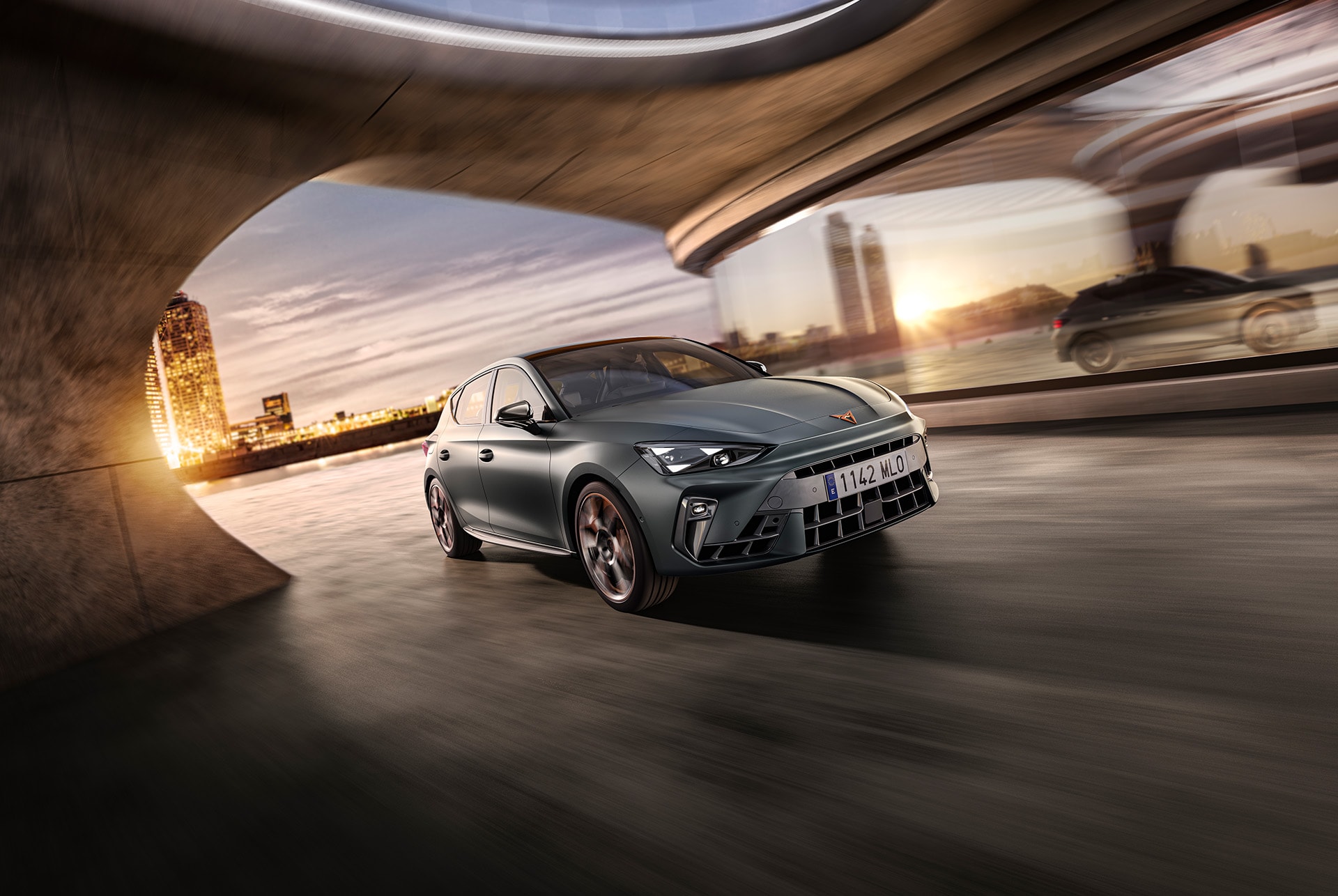 a grey CUPRA Leon driving along a city road