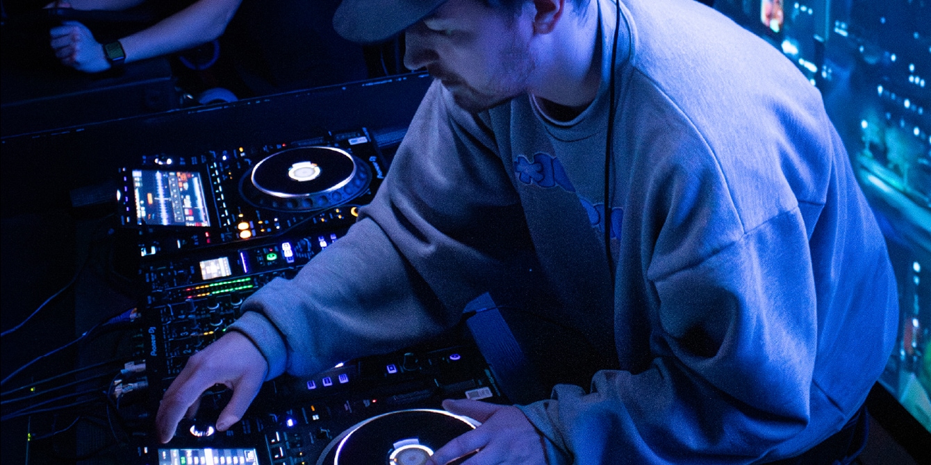 A close-up of a pair of hands using a DJ deck