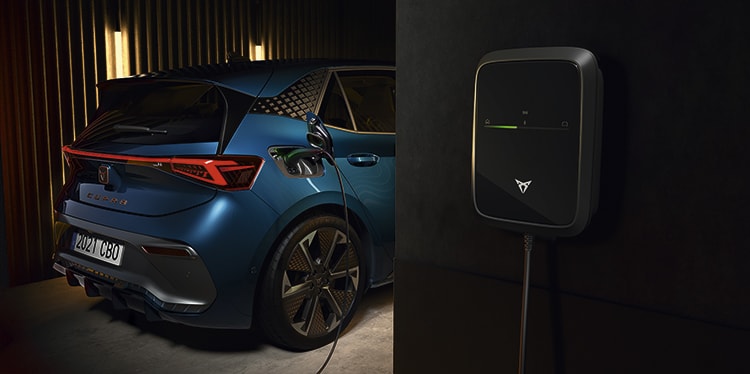 the electric cupra born car plugged into ev wall charger with remote charging benefits such as start, stop and schedule function