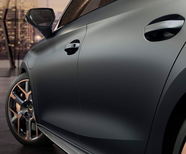 close up of a silver CUPRA Leon's exterior with focus on the door and front wheel