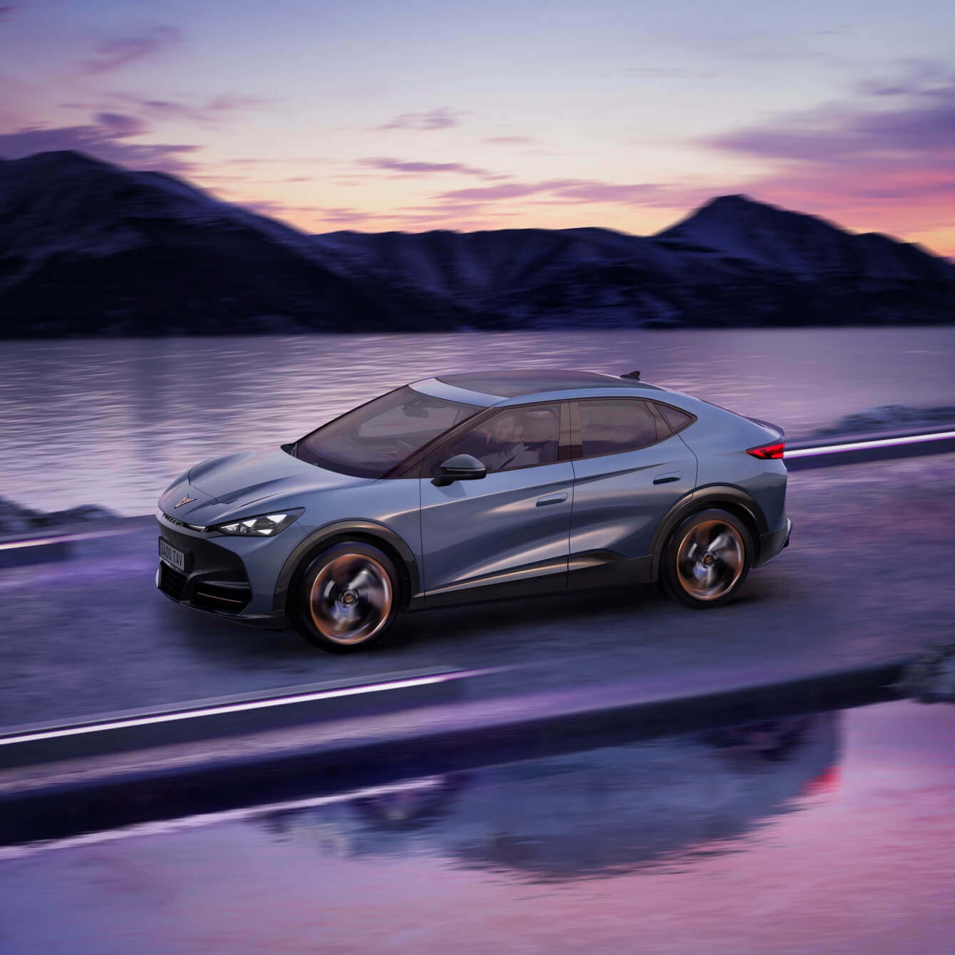 A blue CUPRA Tavascan electric car driving on a road during sunset.