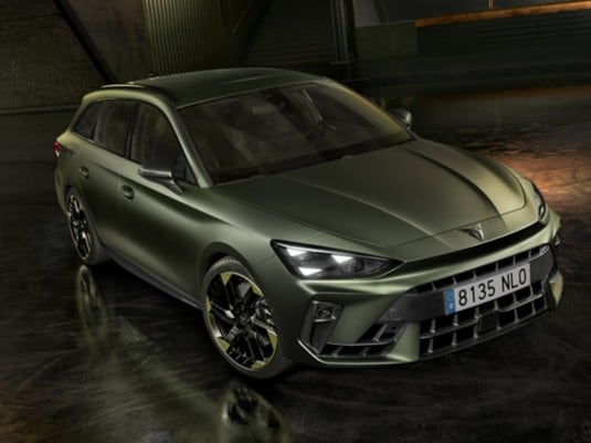 Cupra leon for sale, hatchback in magnetic tech matt grey with 19 inch polar copper wheels and illuminated city background. New car offers available.