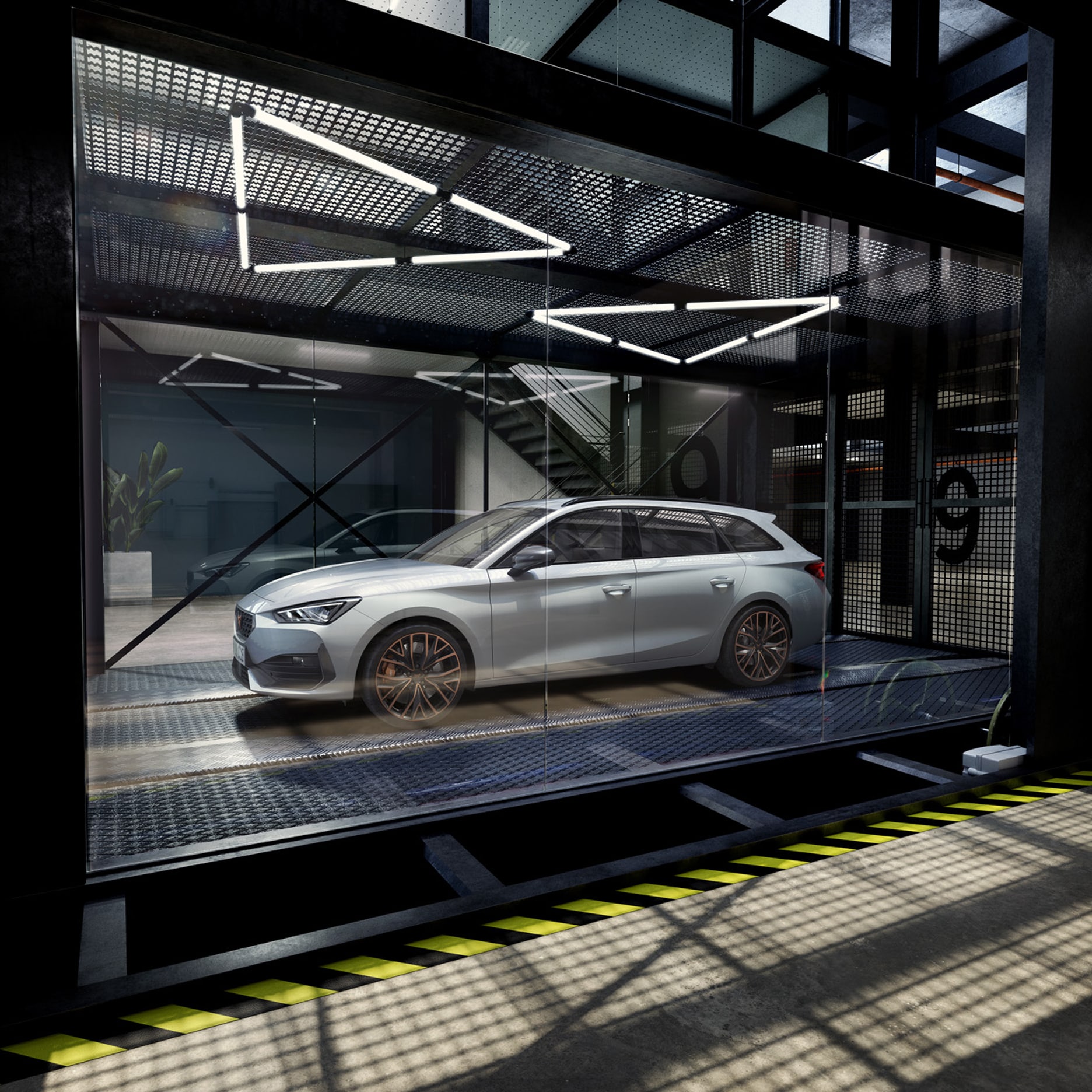 White CUPRA Leon Sportstourer in a modern glass showroom with metallic flooring and sleek lighting.