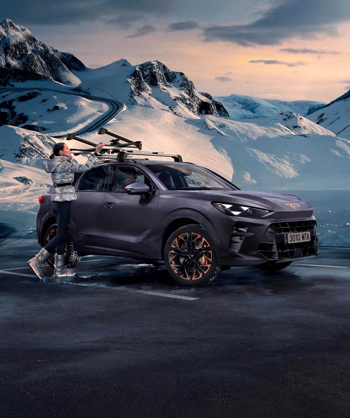 CUPRA Terramar in Dark Void colour parked in a snowy mountain setting, showcasing winter-ready accessories like the ski rack extender.