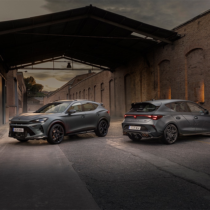 Two grey CUPRA vehicles featuring the CUSTOM CUPRA by ABT pack, parked in an industrial brick lane.