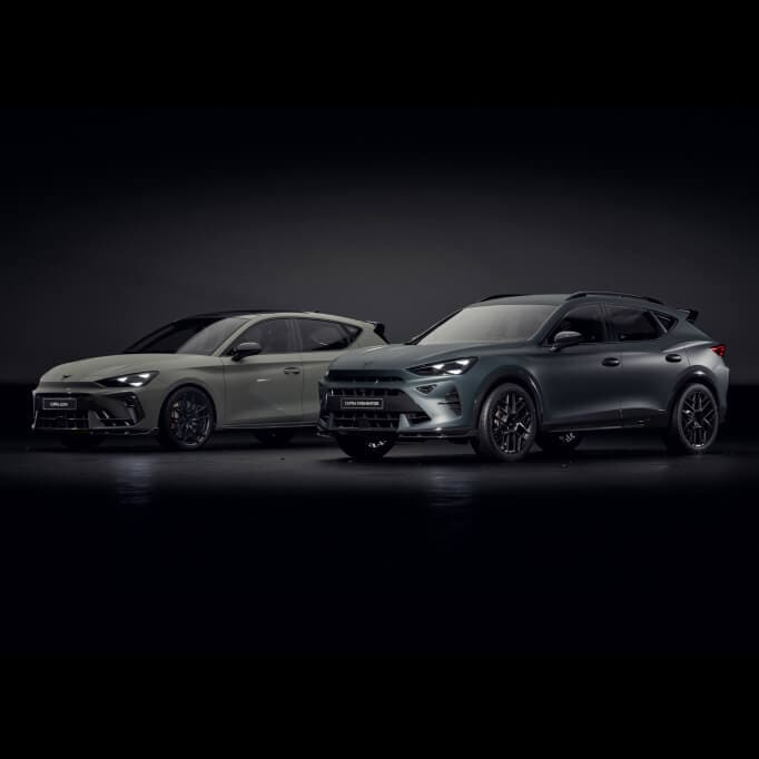 Two CUPRA models side by side: the CUPRA León (left) and CUPRA Formentor (right), shown in dramatic lighting.