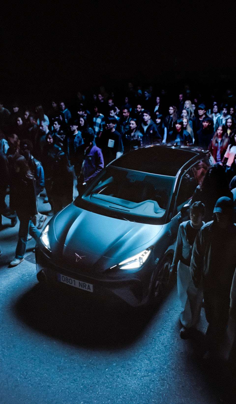 A wide shot of the CUPRA    Raval electric urban car surrounded by    people.  