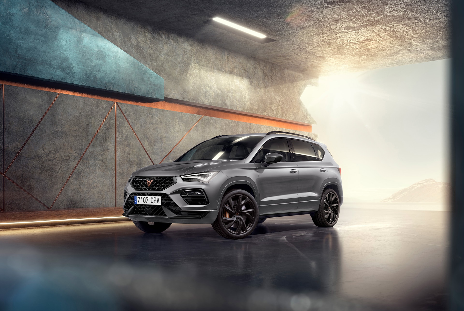 CUPRA CONNECT online services incorporates a range of solutions to answer to the challenges of modern life. A person sitting on stairs at night, using a smartphone illuminated by the screen.