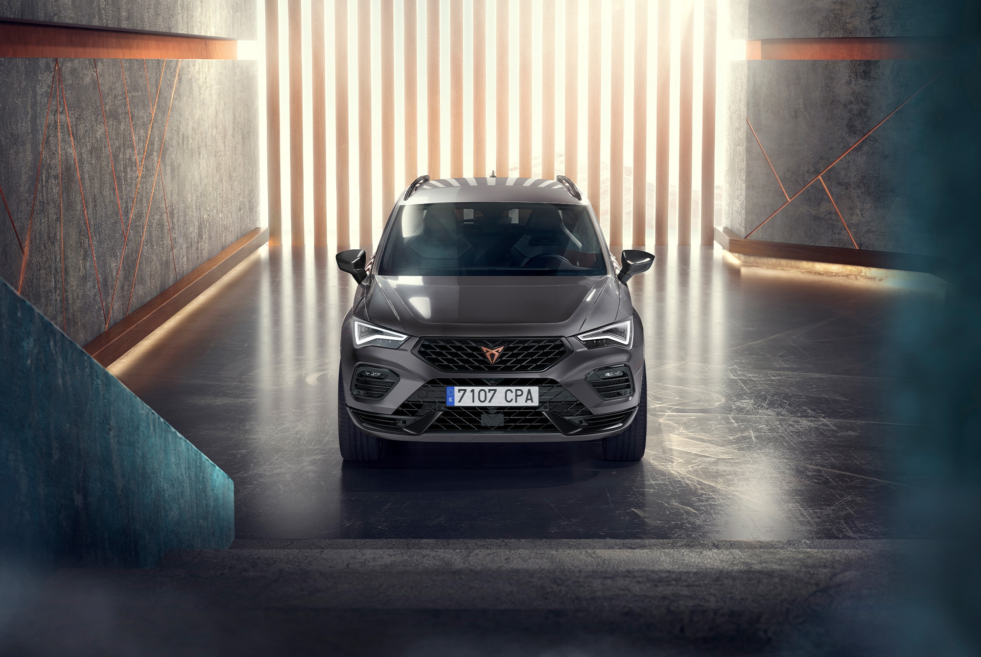 Front view of the CUPRA Ateca showcasing its accentuated bonnet, full LED headlights, dark aluminium detailing and performance brakes with Brembo calipers.