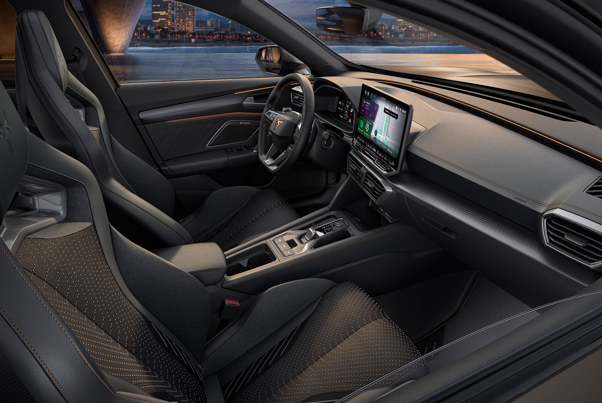 Interior view of a new CUPRA Formentor 2025 interior with sporty seats, detailed stitching, a multifunctional steering wheel, large infotainment screens and a sleek dashboard design. The car overlooks a cityscape at dusk through the windshield.