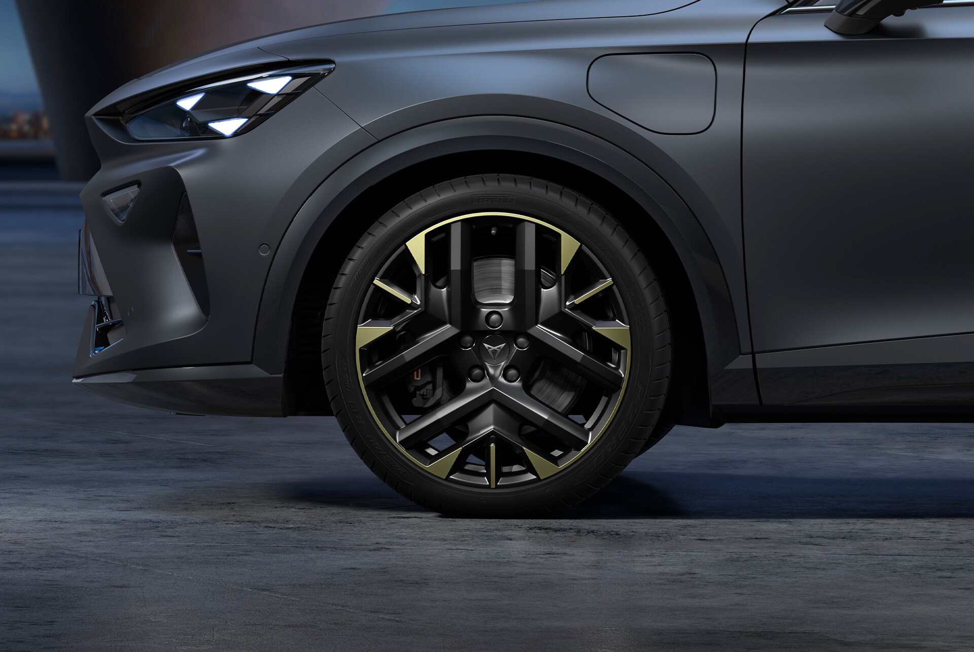 Front side view of left CUPRA alloy wheel in sulfur, tyres and signature headlights, from the tribe edition. 