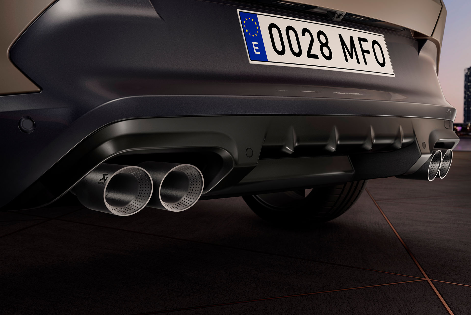 Close-up view of a 2025 CUPRA Formentor's rear. The car features a century bronze matt finish and a sporty design with quad exhausts.