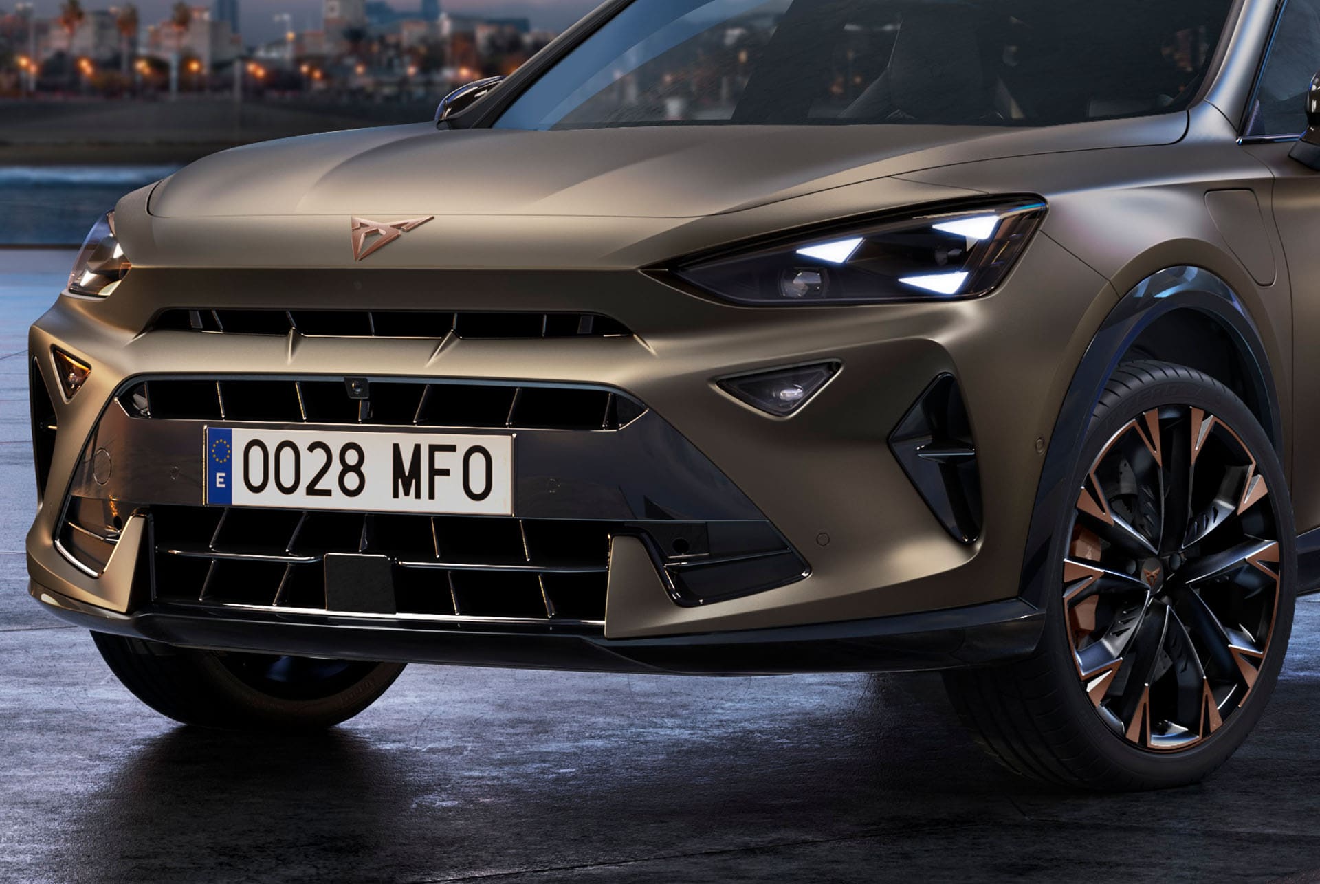 Close up of the front of a new century bronze 2025 CUPRA Formentor CUV with copper accent wheels, signature triangle eye front lights and distinctive CUPRA logo.