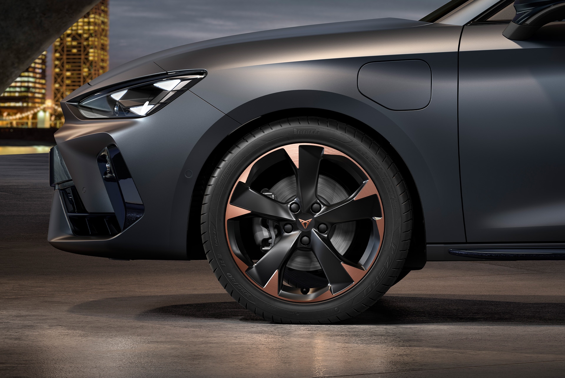 front side view of left mistral garbi copper machined alloy wheels for the cupra leon Sportstourer, tyres, signature headlights and grey body