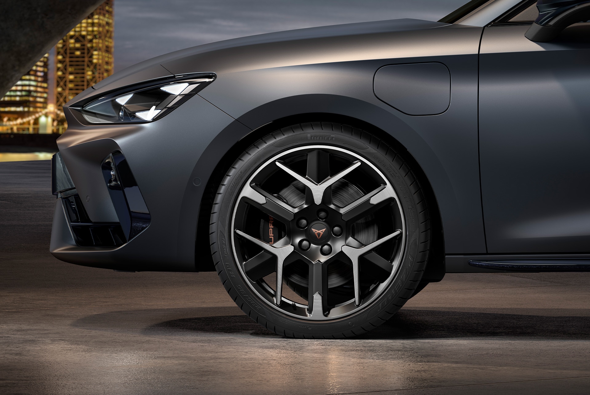 front side view of left forged wheel in silver nd black for the cupra leon Sportstourer, tyres, signature headlights and grey body