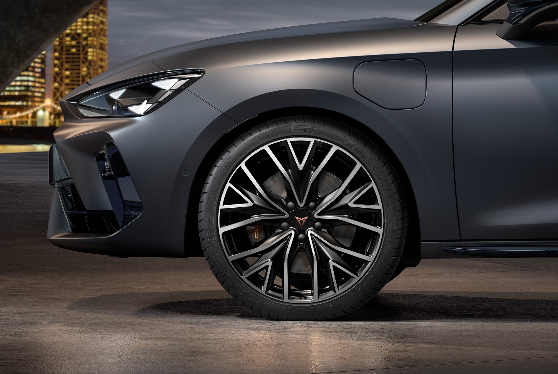 front side view of left mistral machined alloy wheels in silver and black for the cupra leon Sportstourer, tyres, signature headlights and grey body