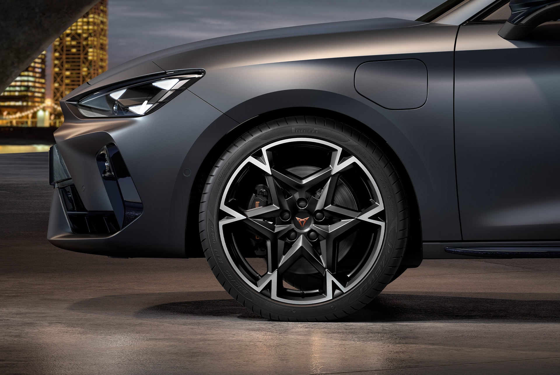 front side view of left machined polar alloy wheel in black and silver for the cupra leon Sportstourer, tyres, signature headlights and grey body