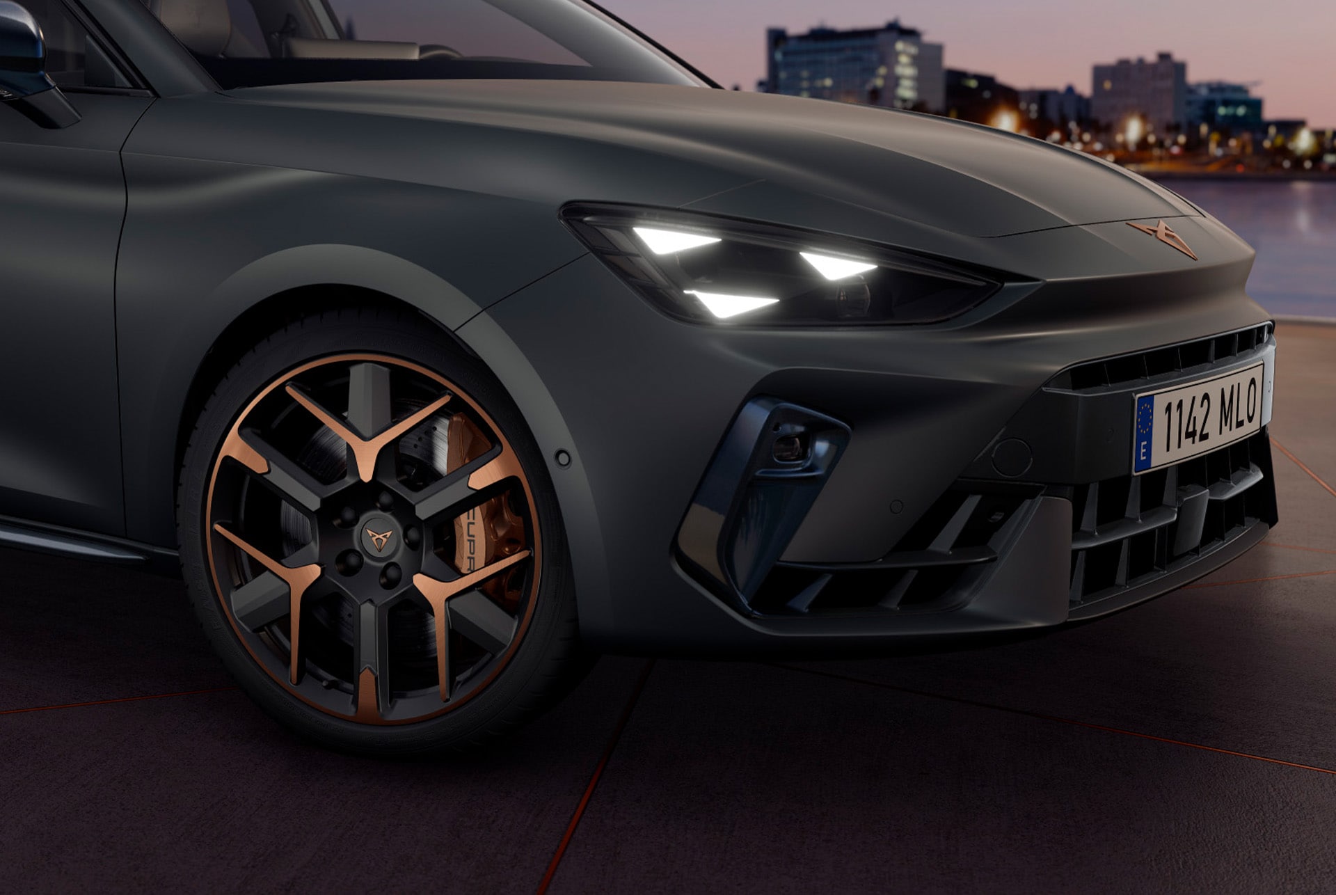 cupra leon sportstourer close up of copper accent and black wheel and triangle eye cupra headlight, enceladus grey matt car body