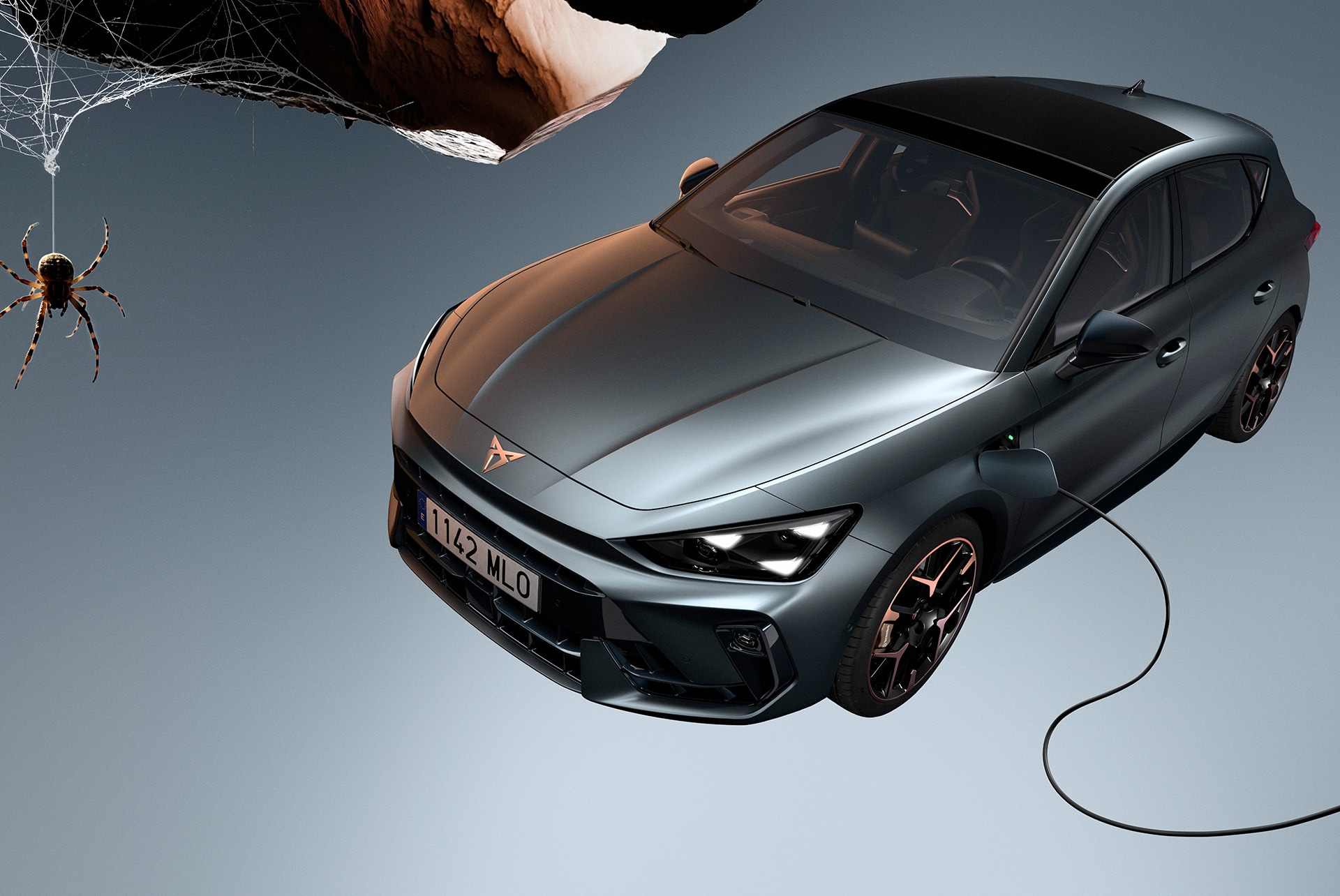 High angle shot of the CUPRA Leon 5D showcasing its desing lines while being charged. 