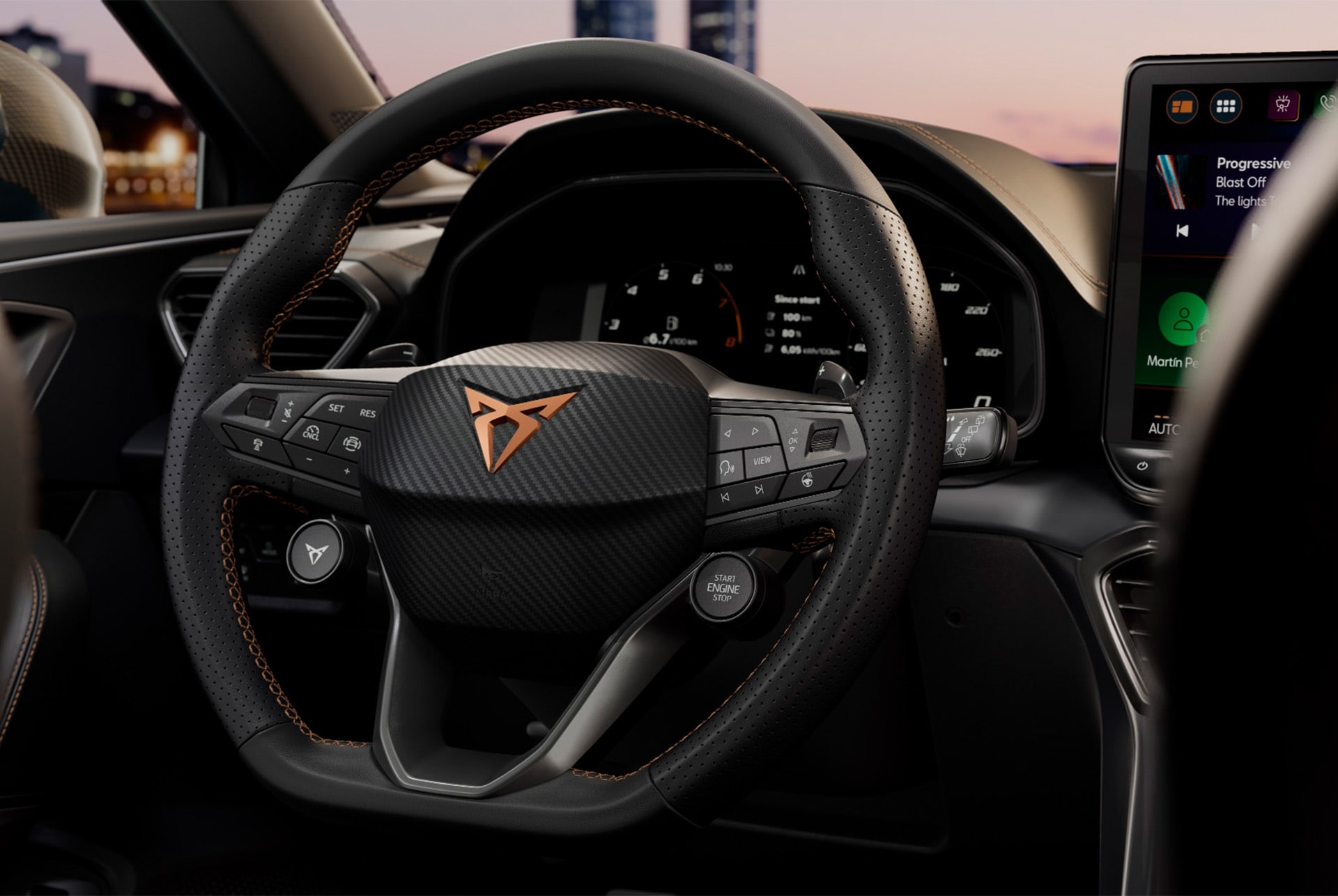 close up of cupra leon technology, steering wheel with satelite buttons, car cockpit, drivers seat view, wing mirror, infotainment system, dashboard door panel, cupra logo and window.