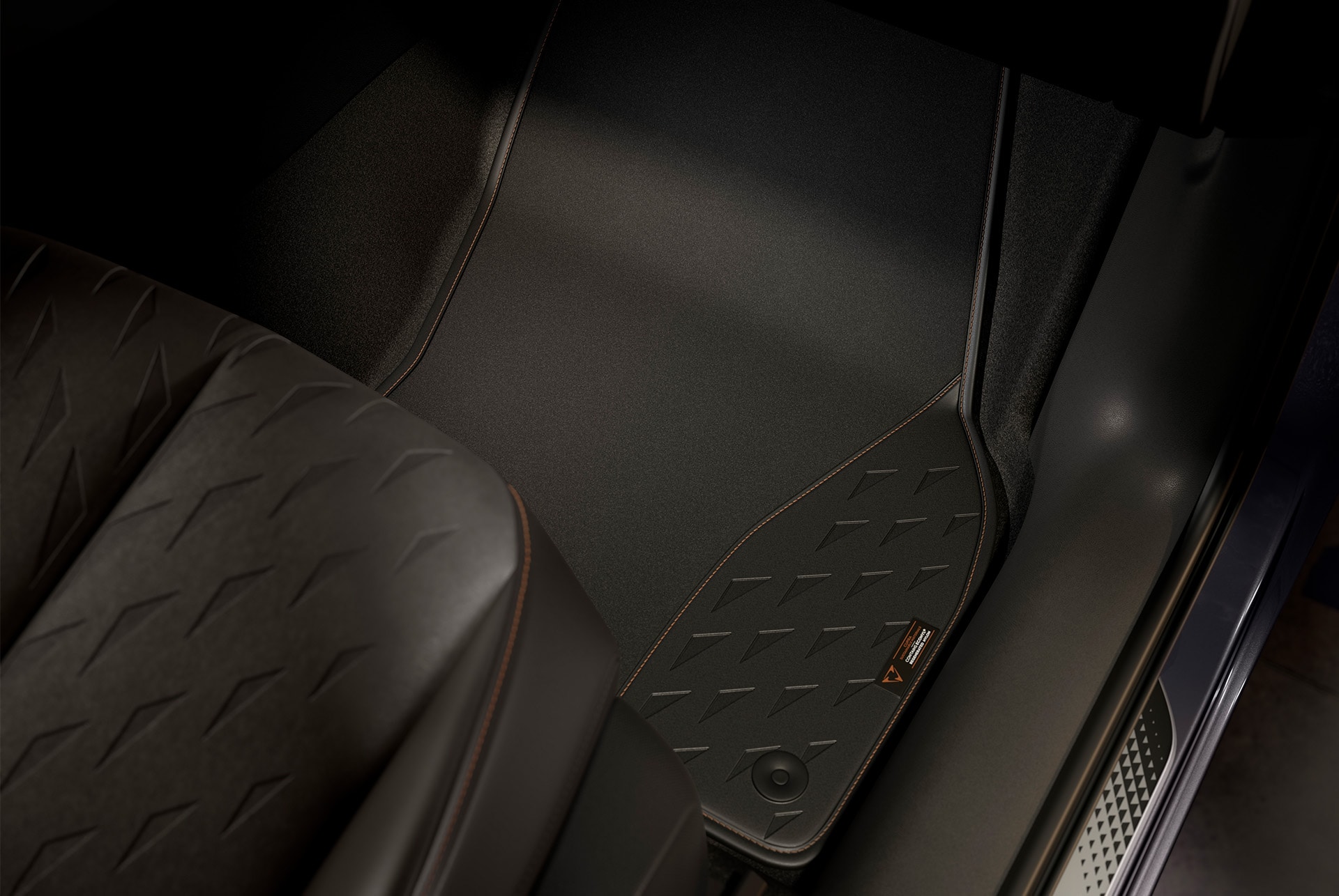 Close-up of the Moon Light Floor Mat and a little part of the seat, to showcase the details high-end details, the triangular CUPRA pattern present in both designs and emphasize the high-quality material of the mats. 