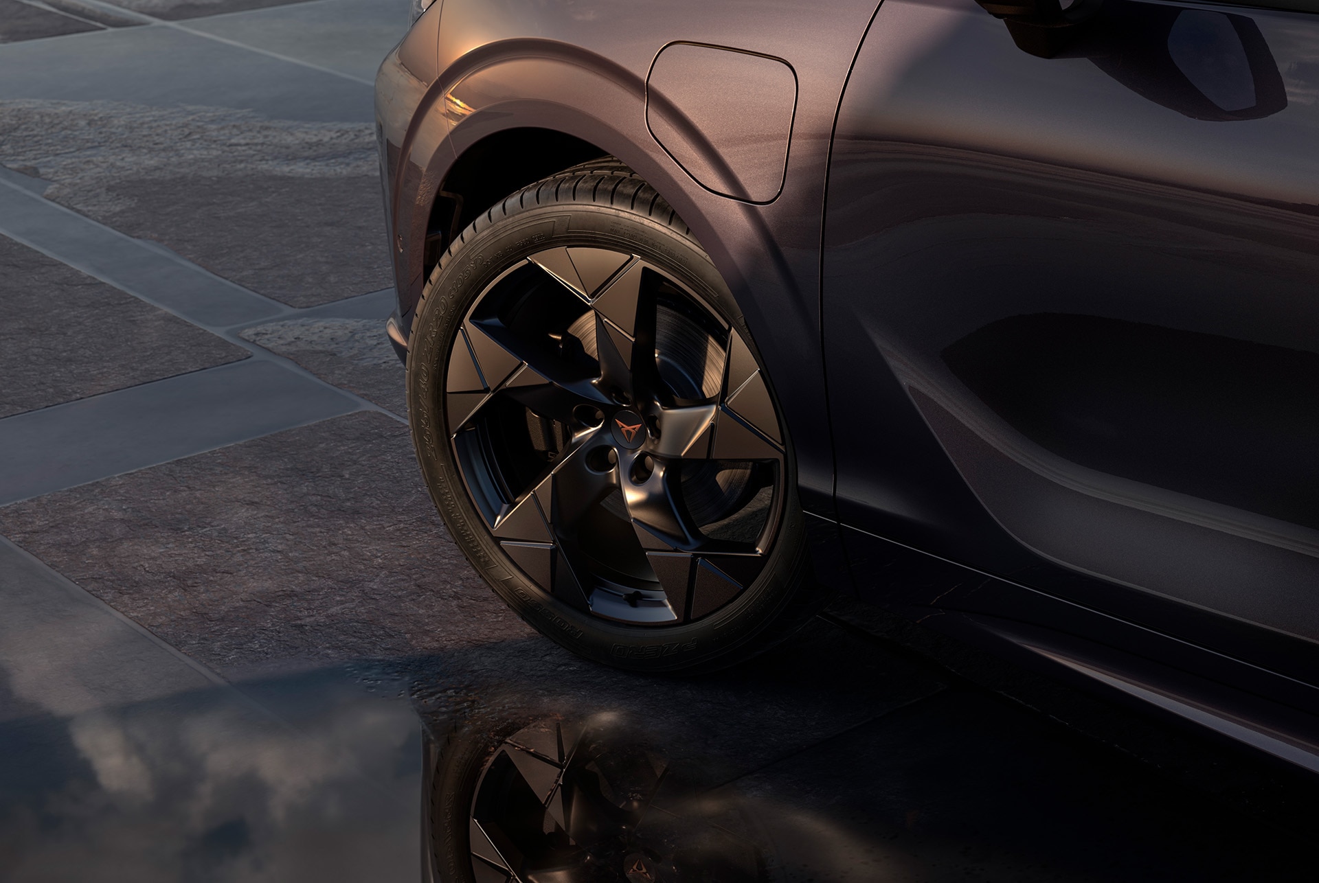 20-inch left alloy wheel in gravity black for the new CUPRA Terramar, against a tiled, dark pavement.