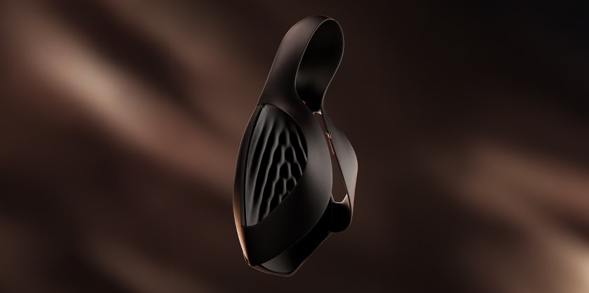 An abstract object, possibly a piece of technology or a design element, is depicted against a blurred brown background.