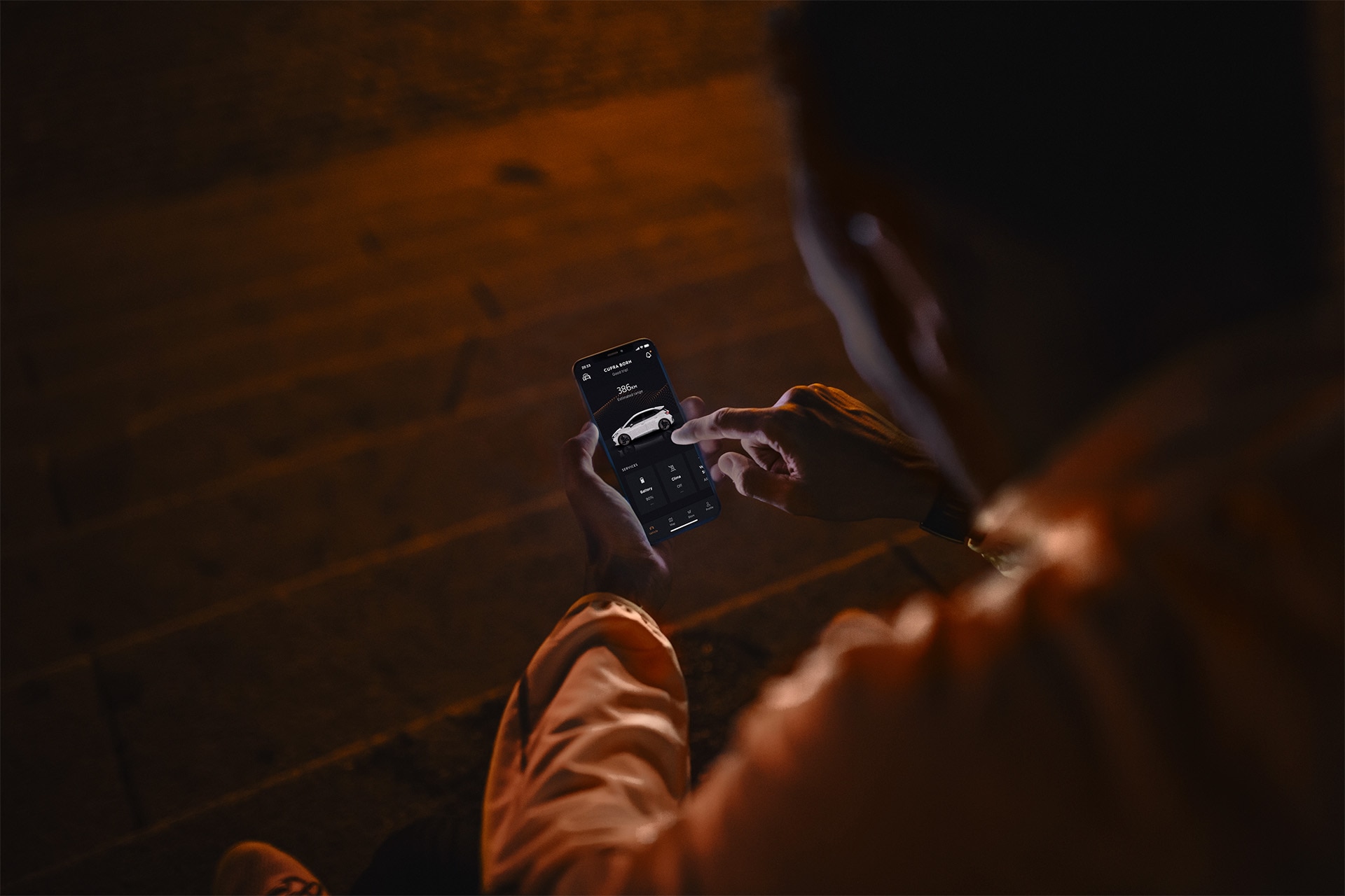 man with a phone using my cupra app