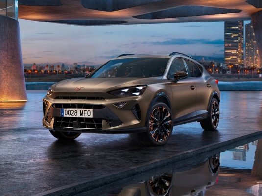 new cupra formentor offer, suv in century bronze matt, model year 2025, with 19 inch artic copper wheels and cityscape background. New car offers available.