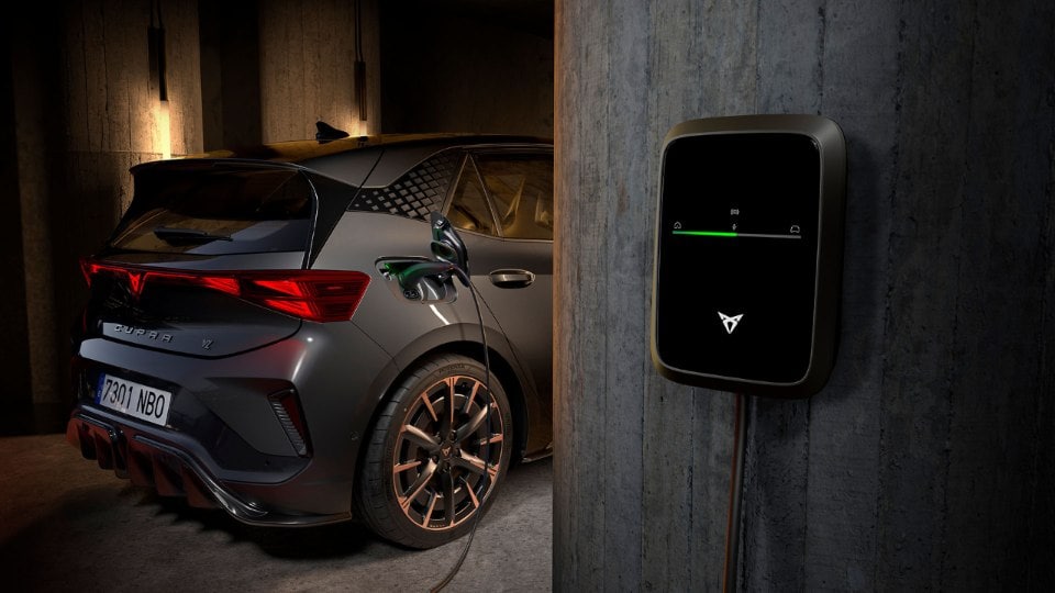 the electric cupra born car plugged into ev wall charger with remote charging benefits such as start, stop and schedule function