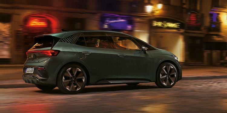 dark forest cupra born electric vehicle in motion