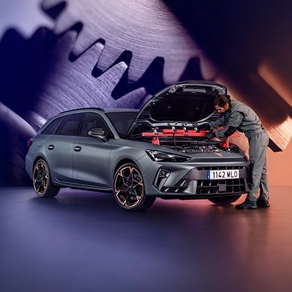 Professional mechanic inspecting a CUPRA engine during a scheduled maintenance service.