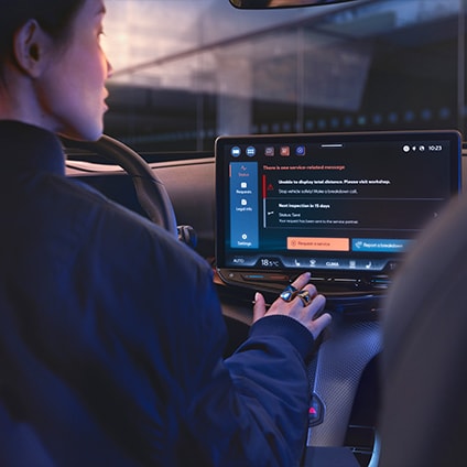 Person using the CUPRA CONNECT digital interface on the car's dashboard screen.