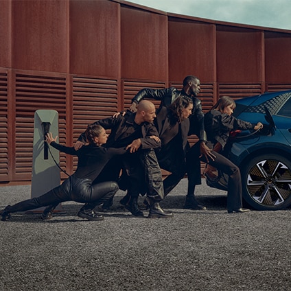 cupra public charging, rear of electriv vehicle cupra born , silver accent wheel and models wearing black
