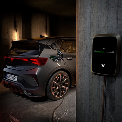 Close-up of a CUPRA electric vehicle charging at a home charging station.