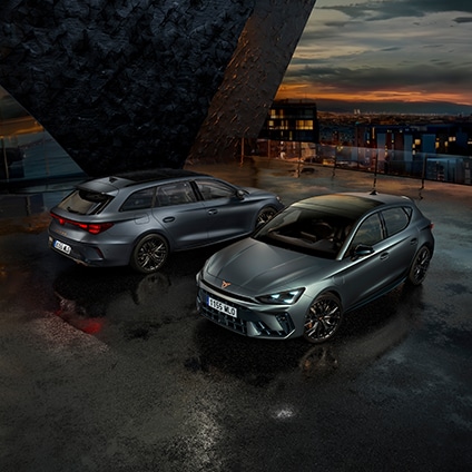 Front view of various CUPRA car models parked at sunset.
