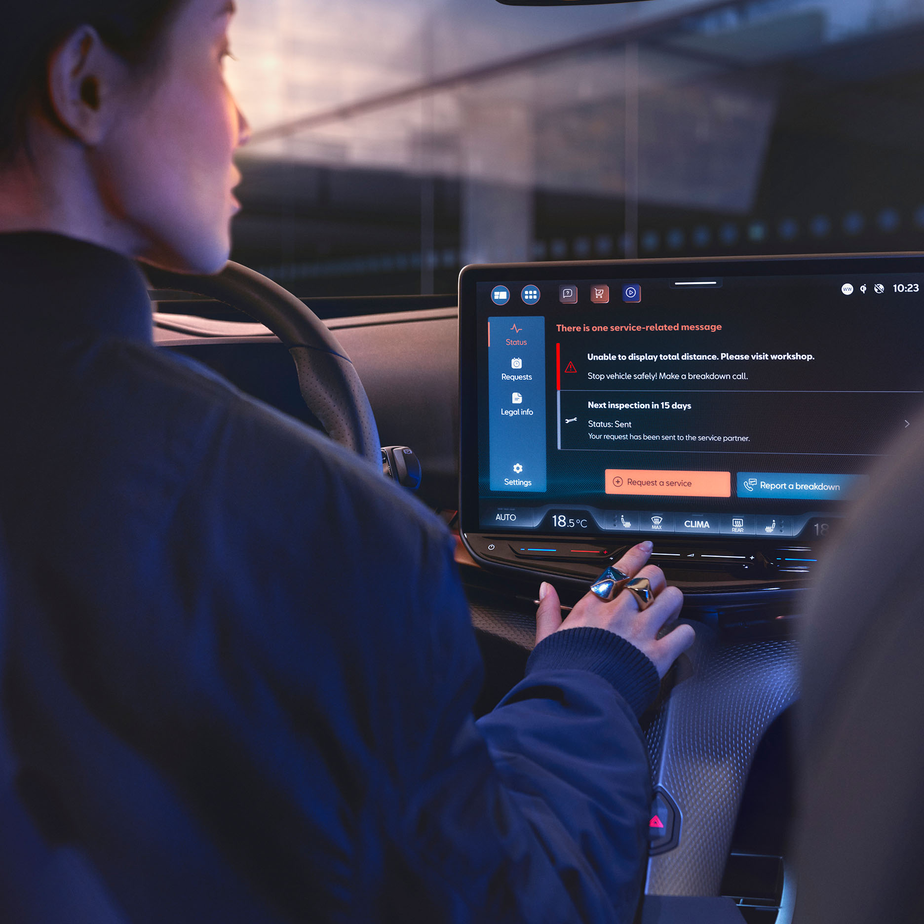 A person is sitting in the driver's seat of a CUPRA car, looking at the large, angled central infotainment screen. The screen displays various icons and a message about the car's status.