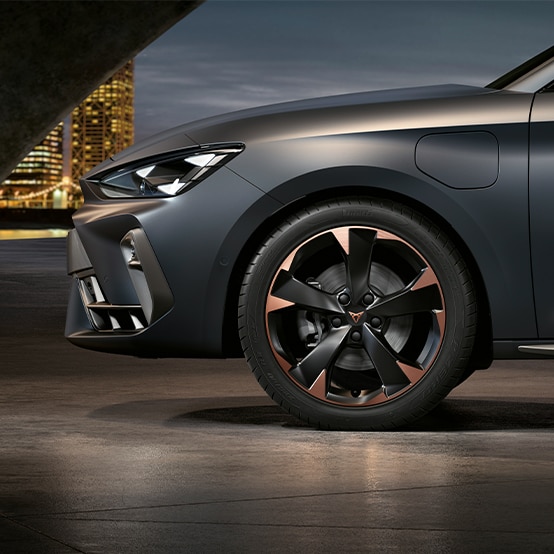 wear and tear inspection, close up of cupra copper accent wheels, brake pads, grey body and skyline