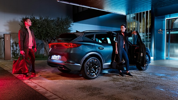 CUPRA Formentor in magnetic grey arriving at a sleek, modern building at night—highlighting style, confidence, and bold presence in every detail.